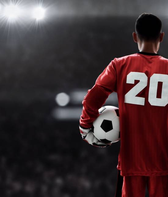 Soccer goalkeeper holding soccer ball Soccer goalkeeper holding soccer ball