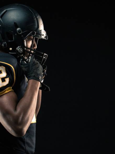 African American football player. African American football player isolated on black